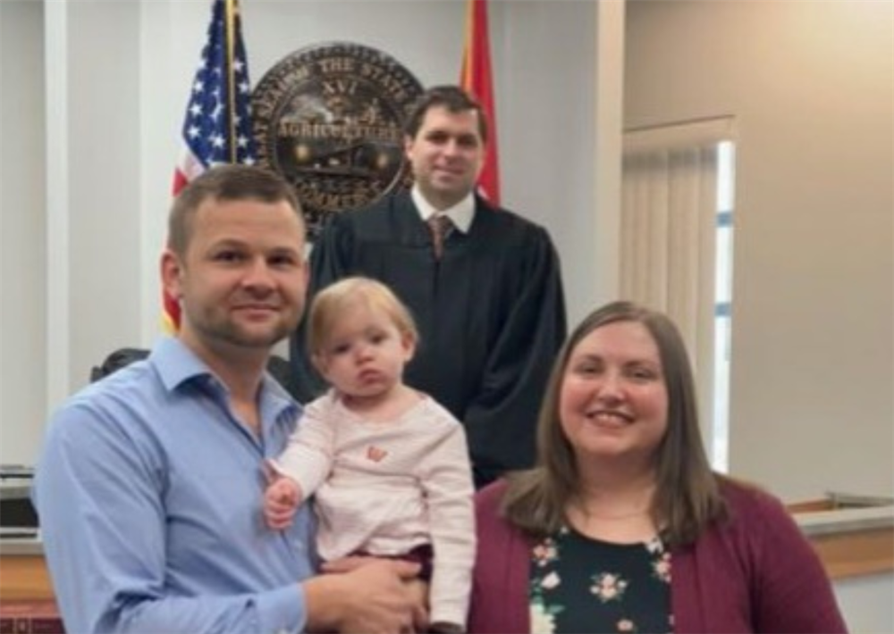 Hana Nash, Corporate Human Resources Manager, right, with her husband, Jonathan, and daughter, Adella, on her adoption day.